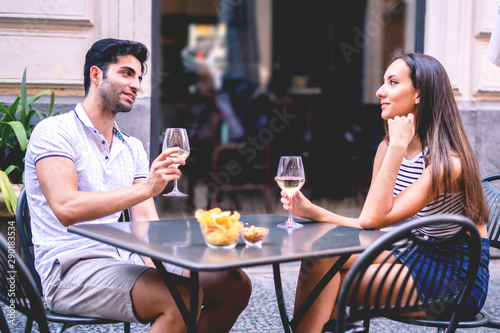 young couple in cafe drinking wine