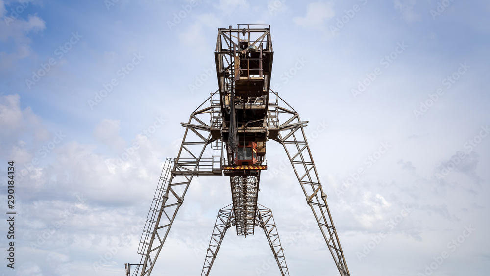 Large metal gantry cranes at a construction site against the blue sky. Type of bearing metal structures of gantry crane  for loading goods