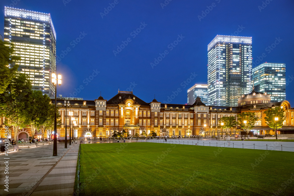Tokyo railway station and Tokyo modern high rise building at twilight time. Chiyoda city, Tokyo, Japan. Host city of the Olympic Games 2020.