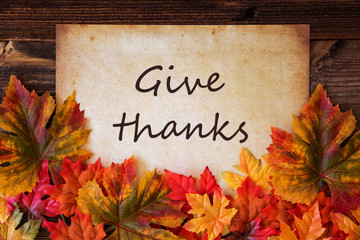 Grungy Old Paper With English Text Give Thanks. Colorful Autum Decoration With Leaves