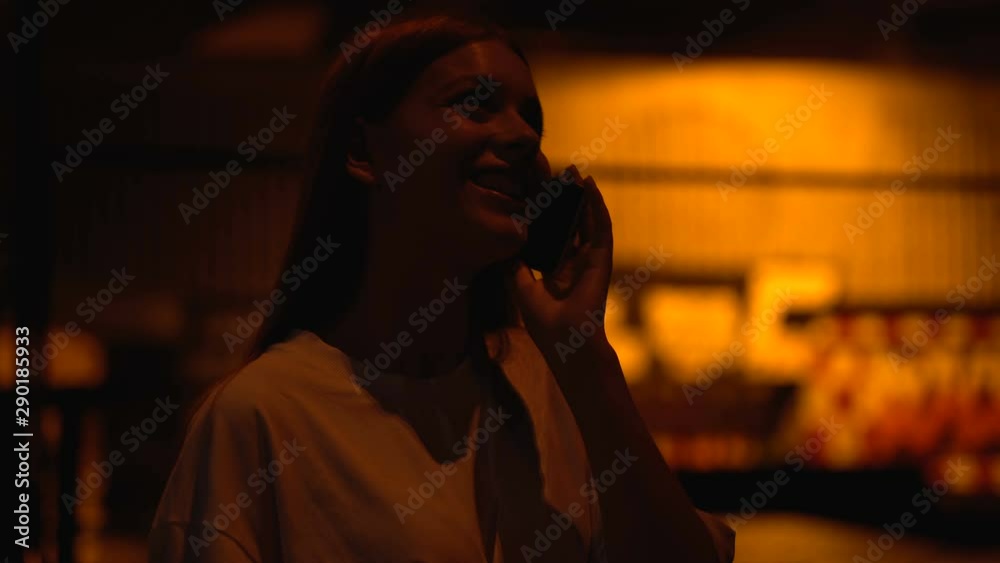 Girl spending time at night-club dancing and talking phone with boyfriend Girl spending time at night-club dancing and talking phone with boyfriend