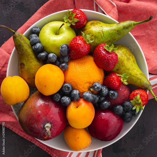 Fruits plate on a dark background top view