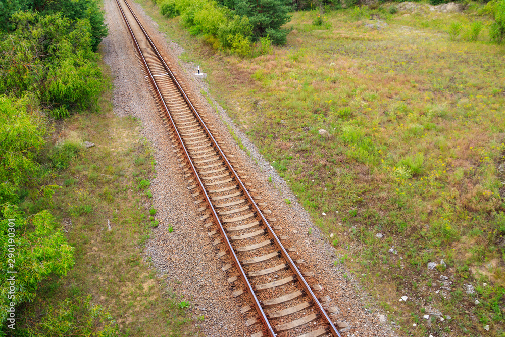 Aerial view of railroad track through a green pine forest Aerial view of railroad track through a green pine forest