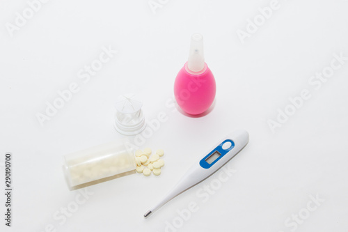 The medicine. Prevention of colds and flu. Enema for cleansing the intestines, yellow tablets in plastic packaging, a thermometer for measuring body temperature. Flat ley on a medical subject.