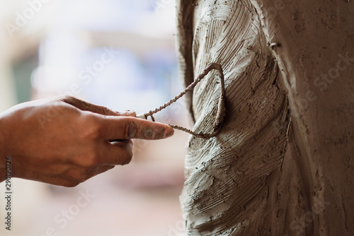 Canvas Print Selective focus sculptor hand molding clay