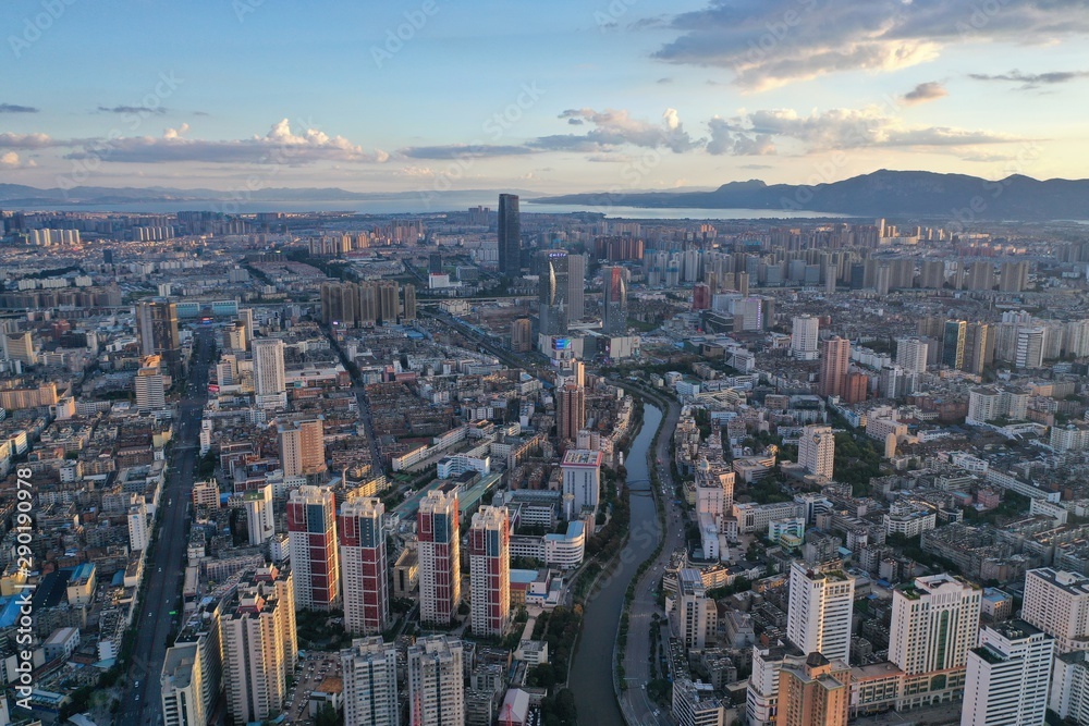 Kunming, China - September 13, 2019: Aerial view of Kunming at sunset with the Dianchi lake on background