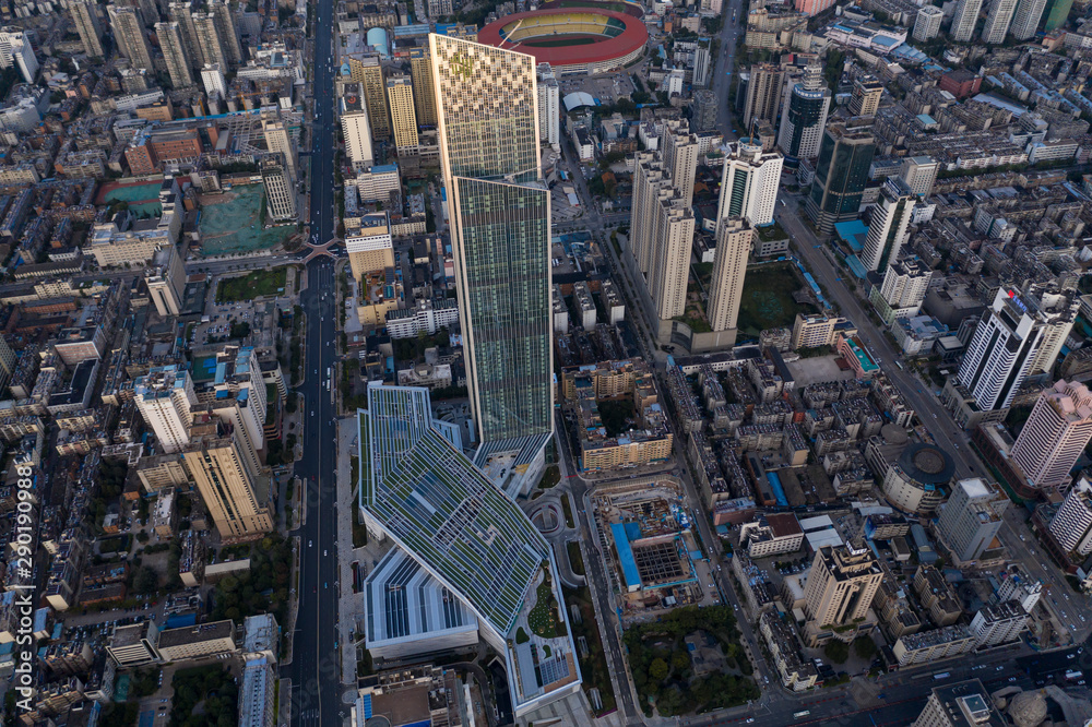 Kunming, China - September 13, 2019: Aerial view of Kunming at sunset with the Spring City 66 skyscraper and mall on foreground