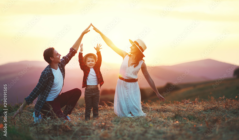 Happy family father of mother and child son  on nature at sunset - obrazy, fototapety, plakaty 