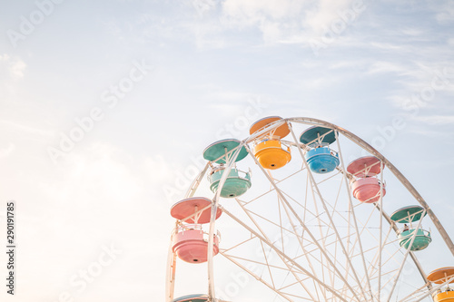 colorful ferris wheel against a pastel sky