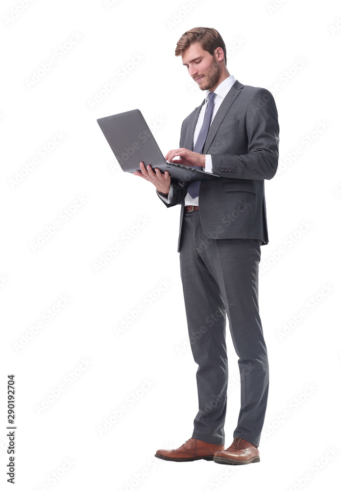 in full growth. businessman standing with open laptop