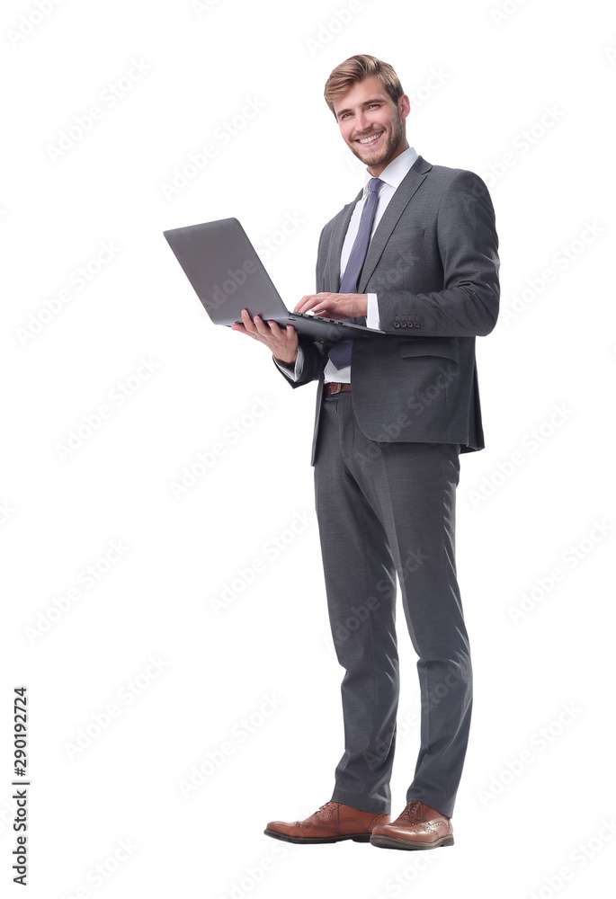 in full growth. businessman standing with open laptop in full growth. businessman standing with open laptop