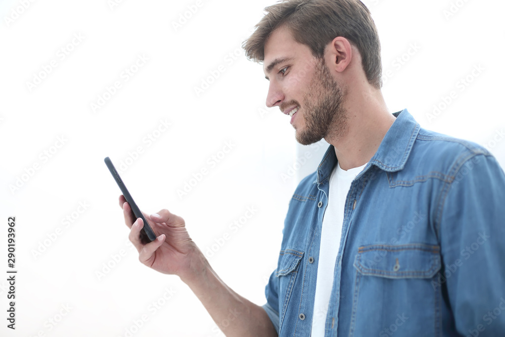 close up. young man reading e-mail on his smartphone. close up. young man reading e-mail on his smartphone.
