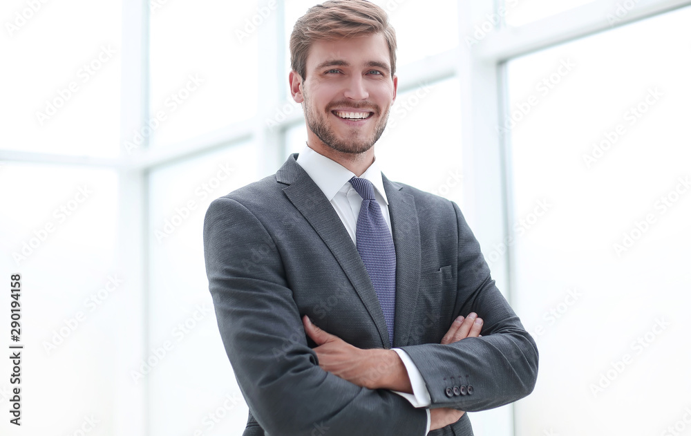 close up.serious young businessman standing in office. close up.serious young businessman standing in office.