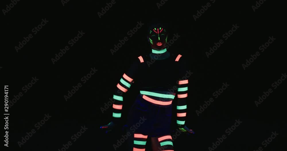 Studio, slow motion, young neon-clad female dances