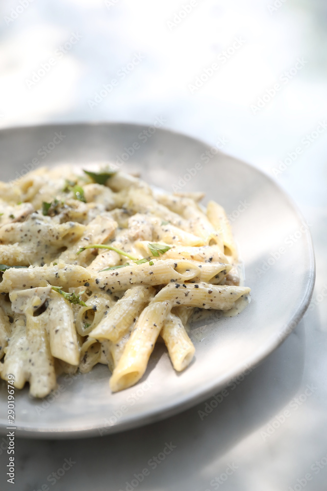 Penne pasta with white sauce and truffle , italian food