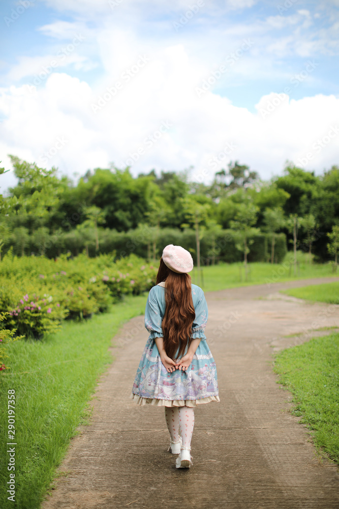 Portrait of asian girl in lolita fashion dress in garden background