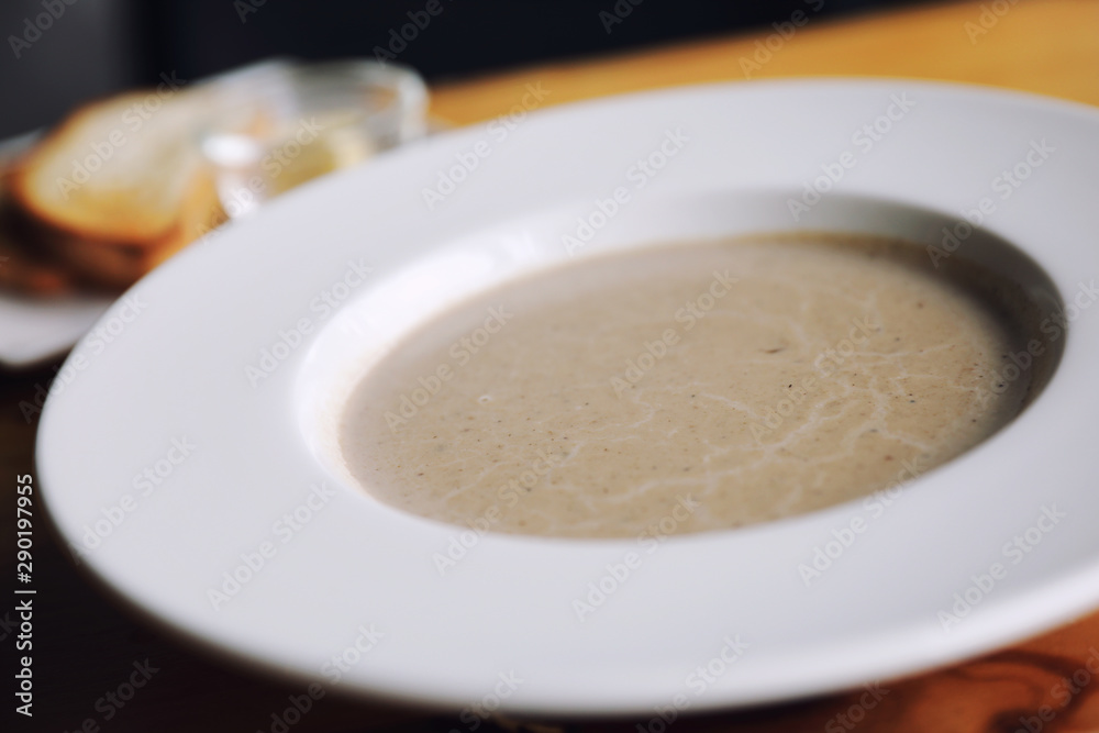 Apptetizer mushroom soup with bread on wood background Apptetizer mushroom soup with bread on wood background