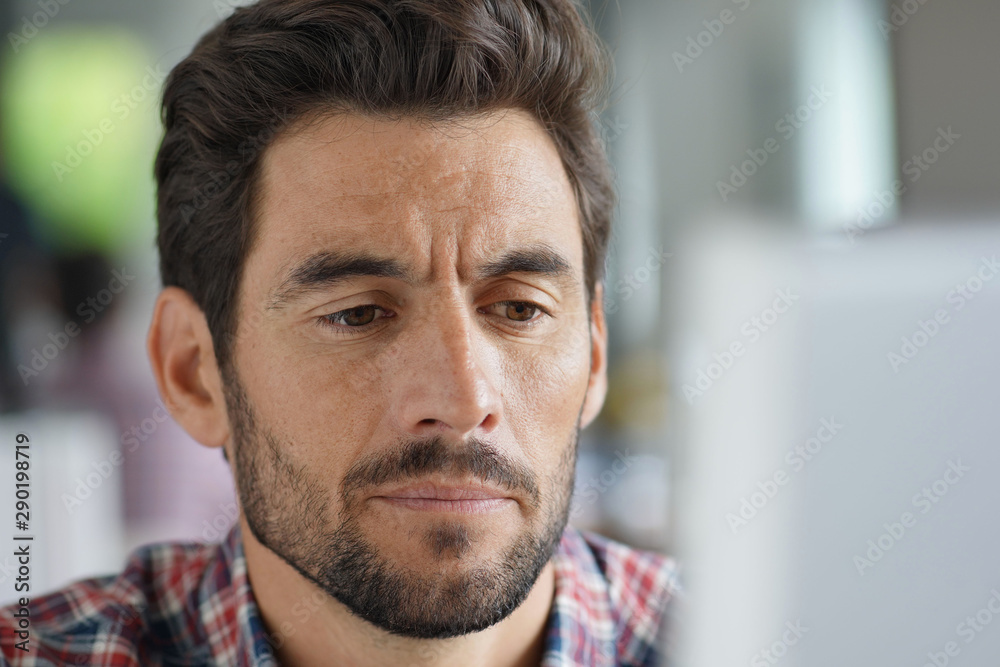 Portrait of a close-up man working on a computer Portrait of a close-up man working on a computer