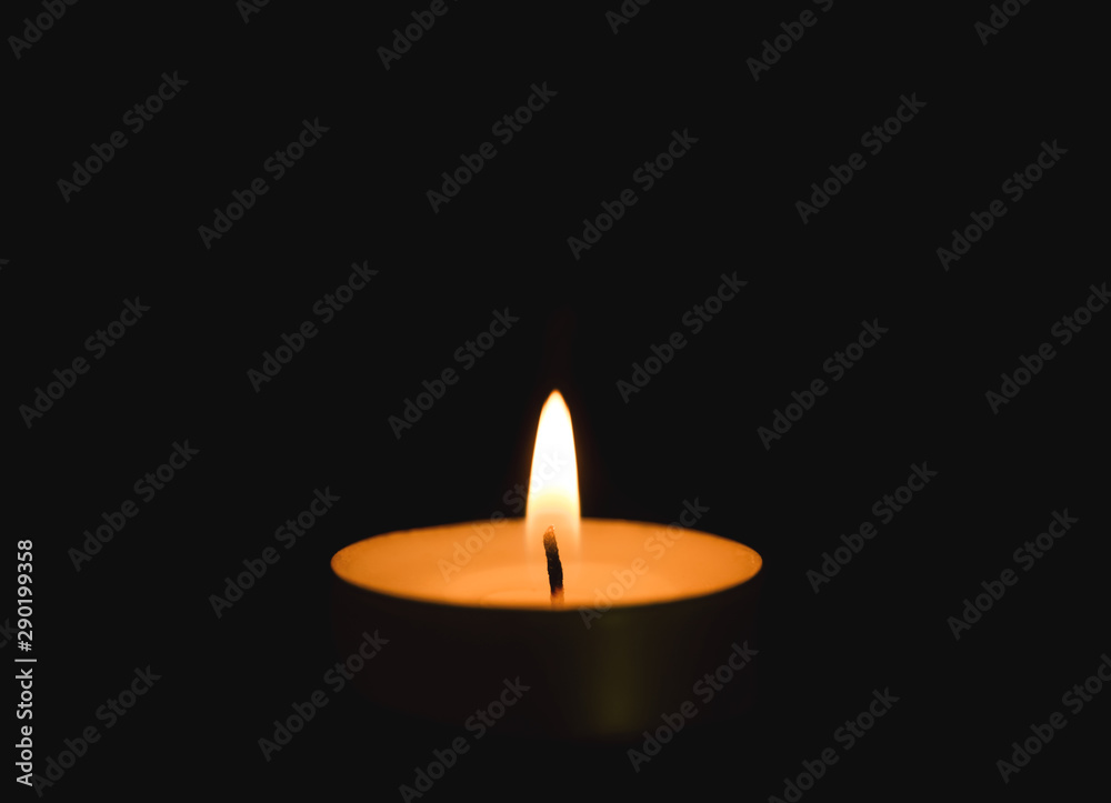 Bright burning candle in darkness. Funeral symbol Bright burning candle in darkness. Funeral symbol