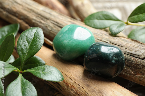 Beautiful green aventurin and heliotrope gemstones with wooden sticks photo