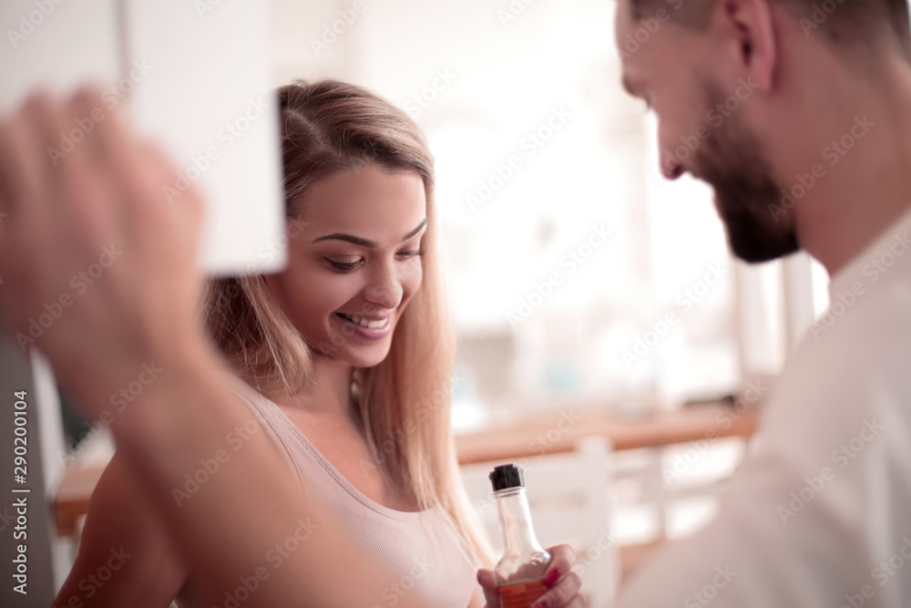 close up. a married couple talking standing in their kitchen. close up. a married couple talking standing in their kitchen.