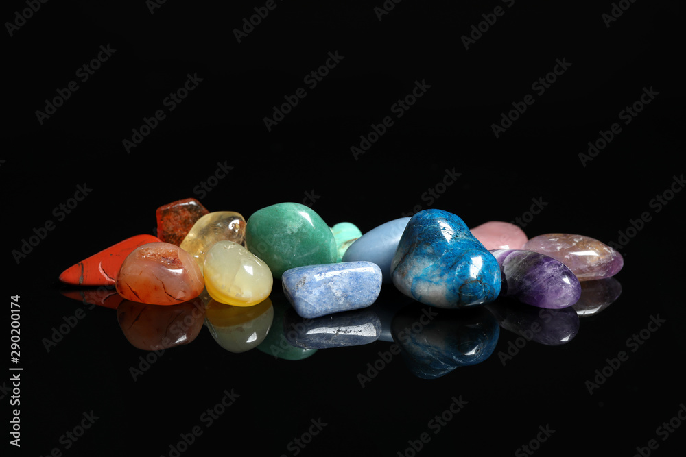 Fototapeta premium Pile of different beautiful gemstones on black background