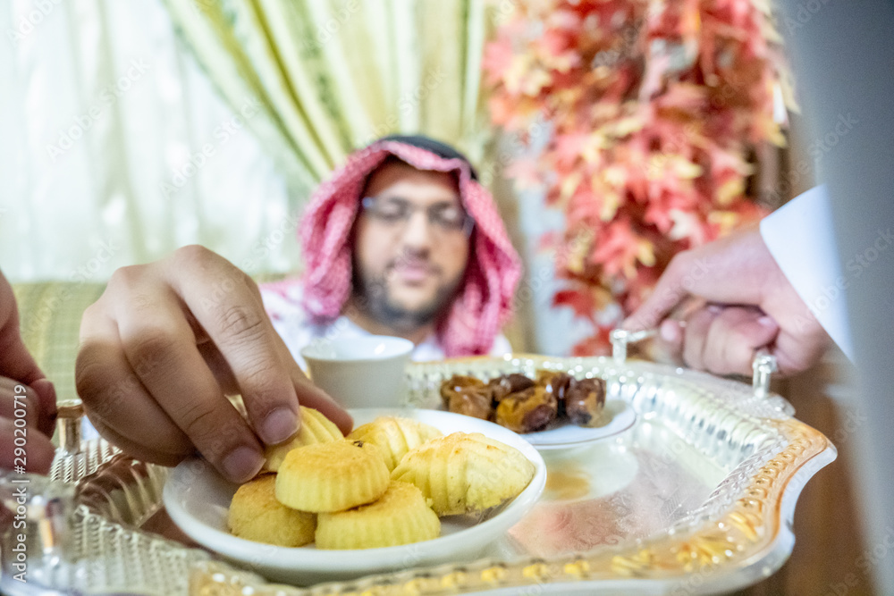 Arabic man serving coffee
