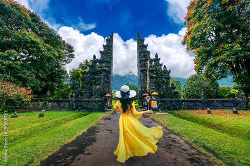 Woman walking at big entrance gate, Bali in Indonesia. photo