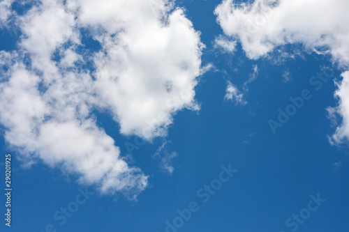 bright blue sky half covered by white clouds. Pure  clear cumulus cloud in sky on sunny day. Earth atmosphere.
