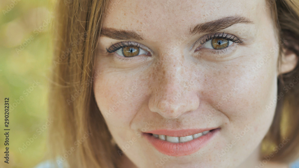 Face close-up of a smiling young girl with freckles. Face close-up of a smiling young girl with freckles.