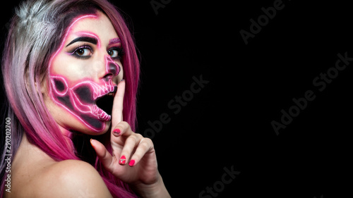  Halloween. Woman in day of the dead mask skull face art. Pink and black skull make up.