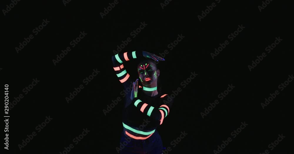 Studio, slow motion, young neon-clad female dances Studio, slow motion, young neon-clad female dances