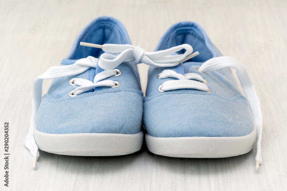 Blue shoes with tied together laces Blue shoes with tied together laces