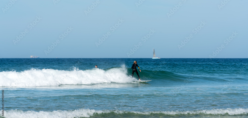 teenager surfing on the west coast of Brittany in France at Toulinguet Beach near Camaret-Sur-Mer