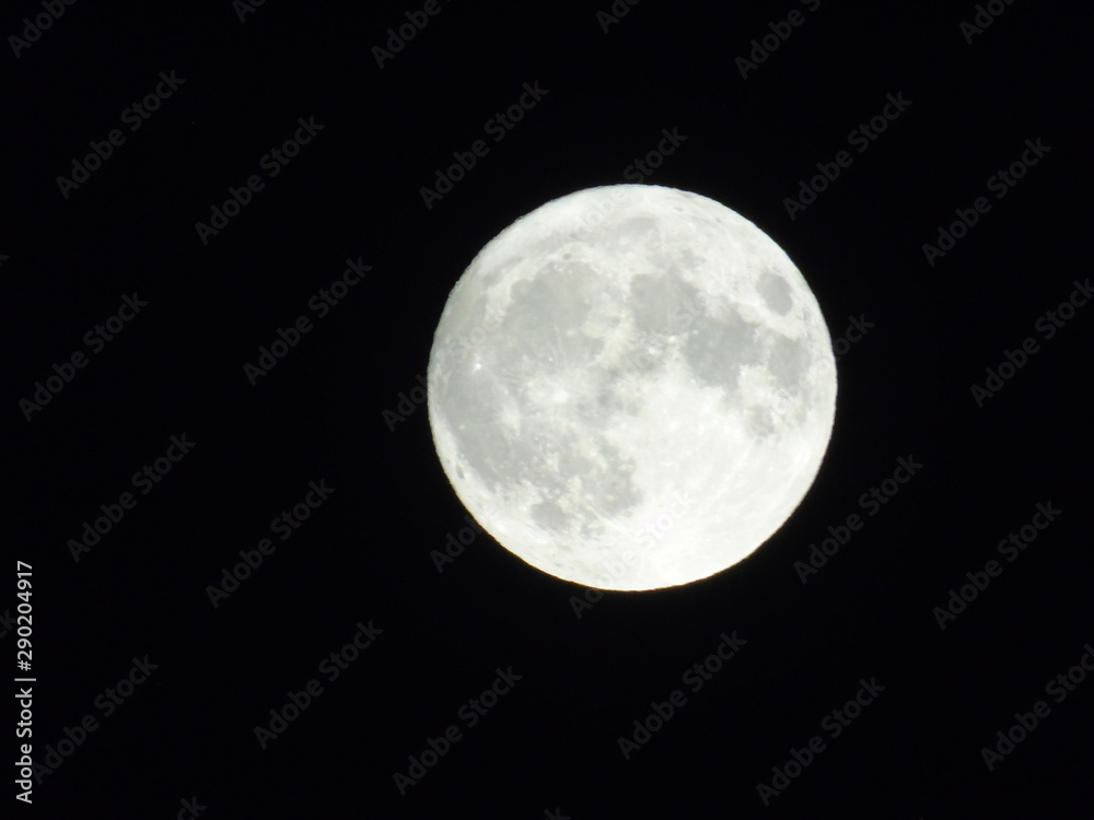 An amazing photography of the full moon over the city of Genova by night with a great clear sky in background and some stars An amazing photography of the full moon over the city of Genova by night with a great clear sky in background and some stars