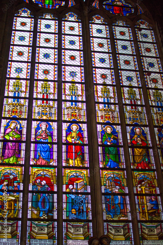 Colorful stained glass window inside of the Saint Bavo Cathedral (or Sint-Baafs Cathedral) in Ghent, Belgium, Europe