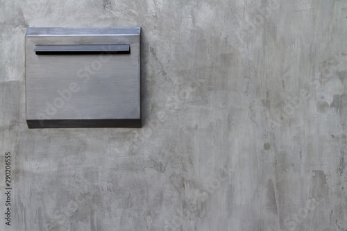 Photo of textured from empty old flat colorless cement wall and matt outdoors aluminum mailbox background.