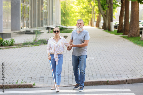 Mature man helping his blin...