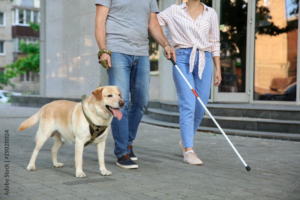 Blind mature man with his daughter and guide dog outdoors Blind mature man with his daughter and guide dog outdoors