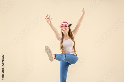 Cool young woman dancing ag...