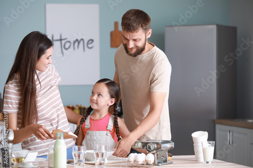 Young family cooking togeth...