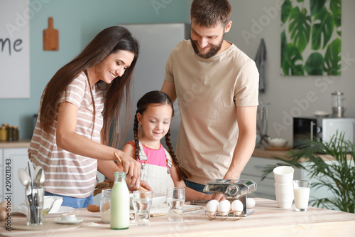 Young family cooking togeth...