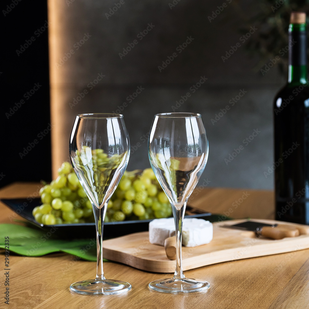 White wine with a box full of grapes on a wooden table. White wine with a box full of grapes on a wooden table.