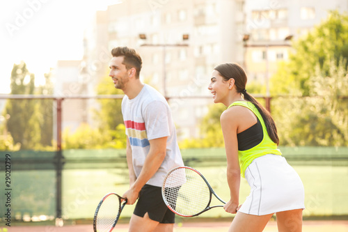 Young couple playing tennis on court © Pixel-Shot