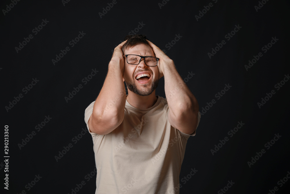 Stressed man on dark background Stressed man on dark background