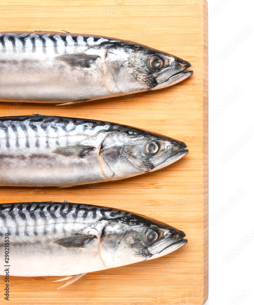 Board with raw mackerel fish on white background