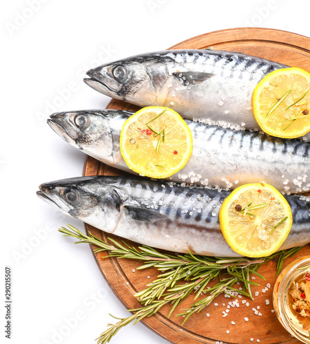 Board with raw mackerel fish and spices on white background