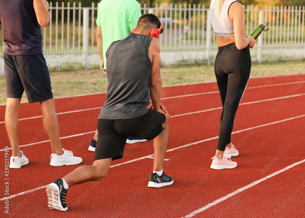 Group of sporty young people at the stadium