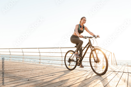 Beautiful young fitness woman cyclist wearing