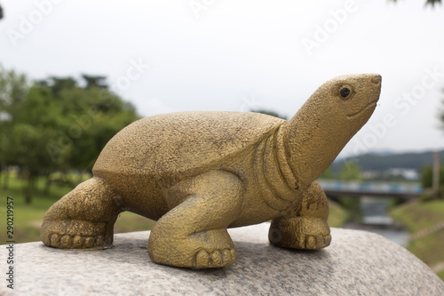 Sculpture of a turtle terrapin  on a parapet.